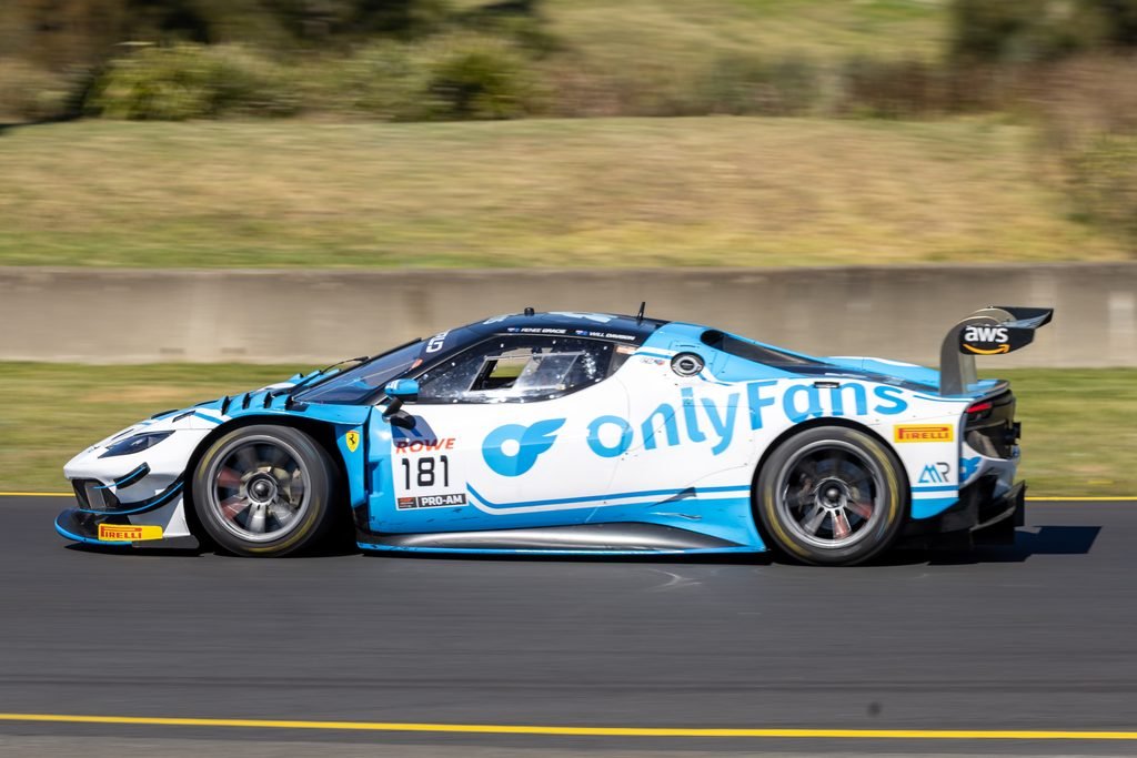 0I1A0151-2 • Sports Rewind Media Blue-and-white racing car speeding on a track, number 181, with AWS branding and Pirelli tires visible on the front left corner.