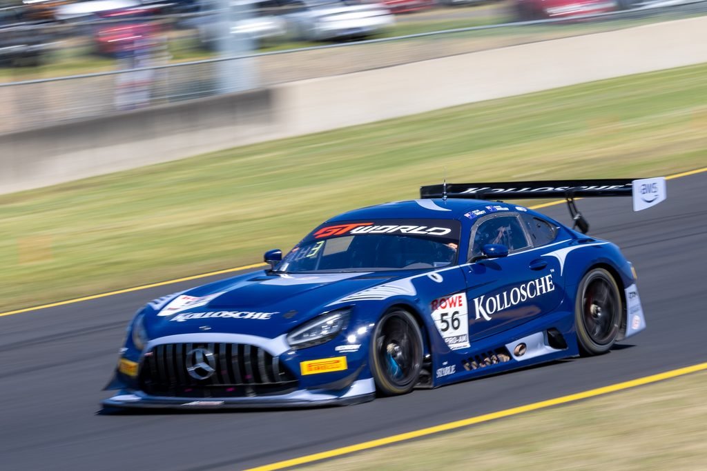 0I1A0197 • Sports Rewind Media Blue race car speeding on a track with blurred background, sponsor logos visible on the body and rear wing design in motion blurs.