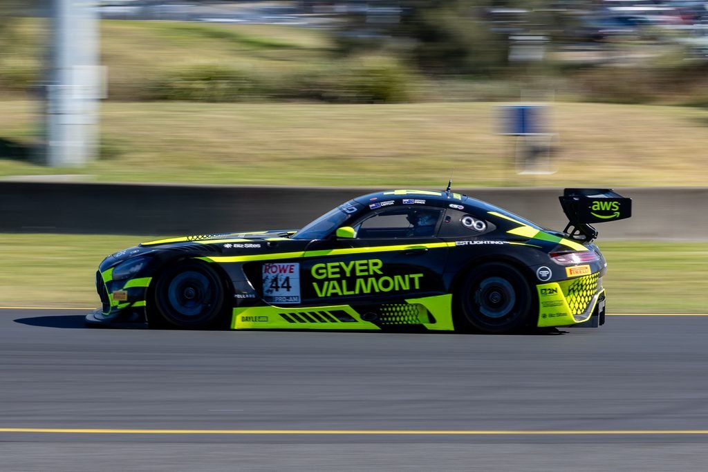 0I1A2468 • Sports Rewind Media Speeding black and neon-green race car (number 44) on a track, motion blur in the background reveals high speed and sponsor decals on the body.