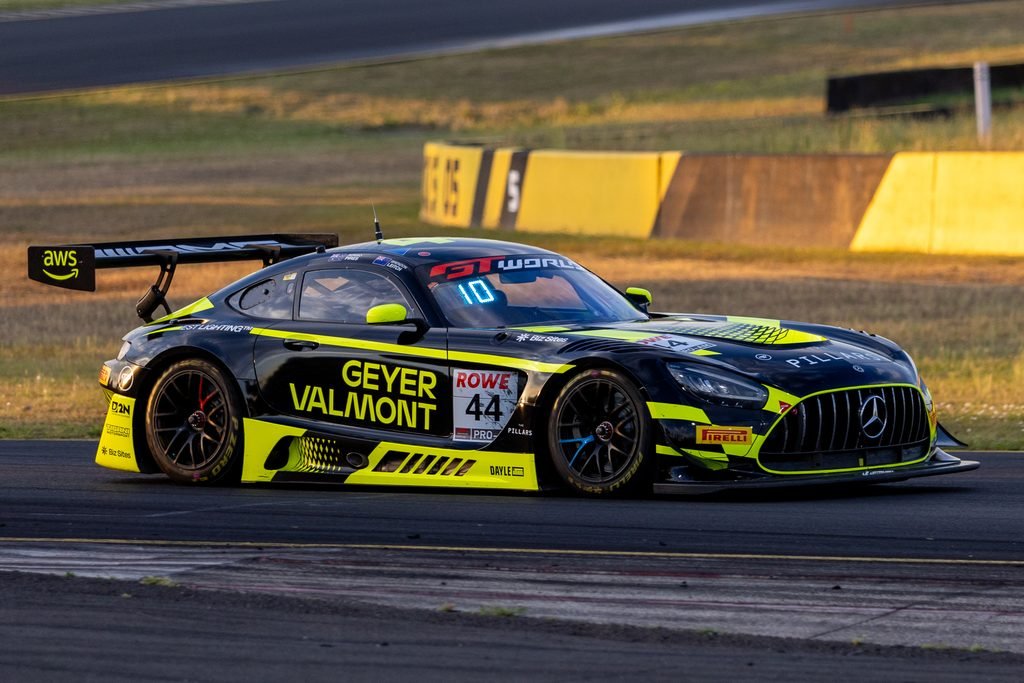 _I1A1612 • Sports Rewind Media Race car number 44 in black and neon yellow livery speeding on a track with sponsor decals visible on the side and rear wing.