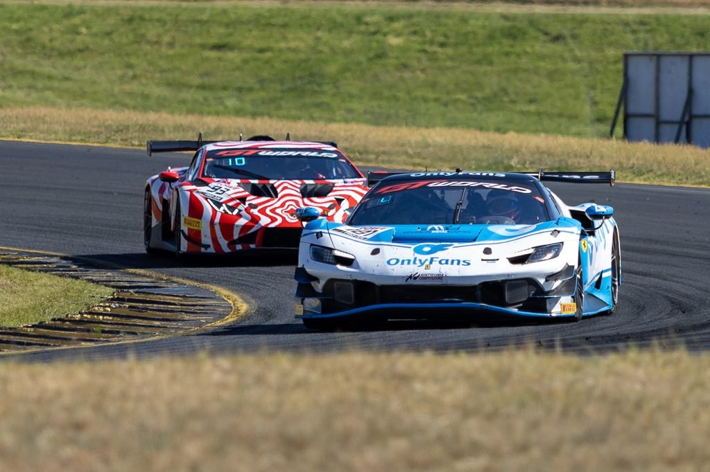 _I1A2394 • Sports Rewind Media Two race cars race side by side on a curving track, blue-and-white car in front with'OnlyFans' branding and a red-wrapped car behind it with a zebra pattern on the livery.